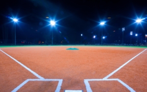 Image of a baseball field lit up at night.