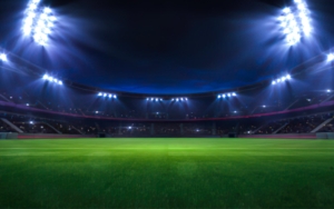Image of a stadium being lit up at night.