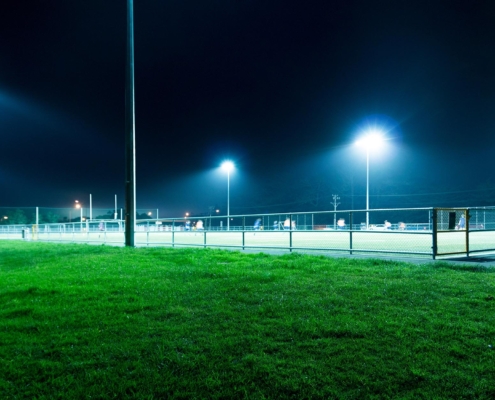 Soccer field lit by lights at night